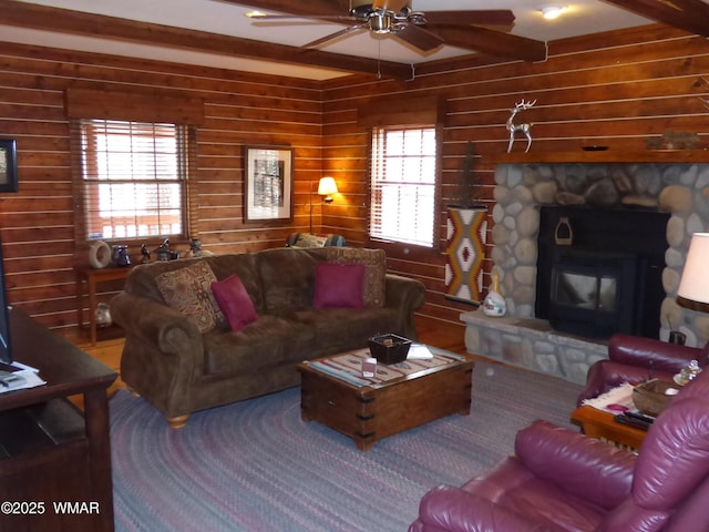 living area with beamed ceiling and ceiling fan
