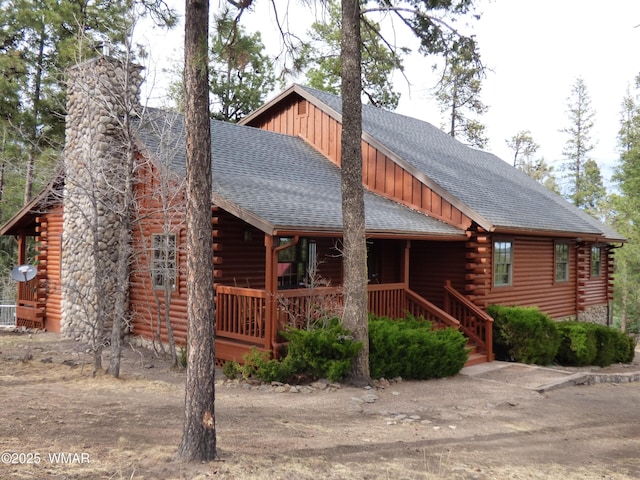 log-style house with board and batten siding, roof with shingles, a chimney, and log siding