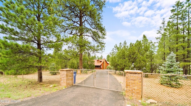 view of gate with a fenced front yard