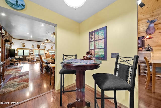 dining area with ceiling fan, baseboards, and wood finished floors