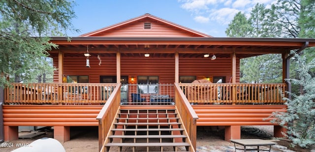 rear view of property featuring stairway