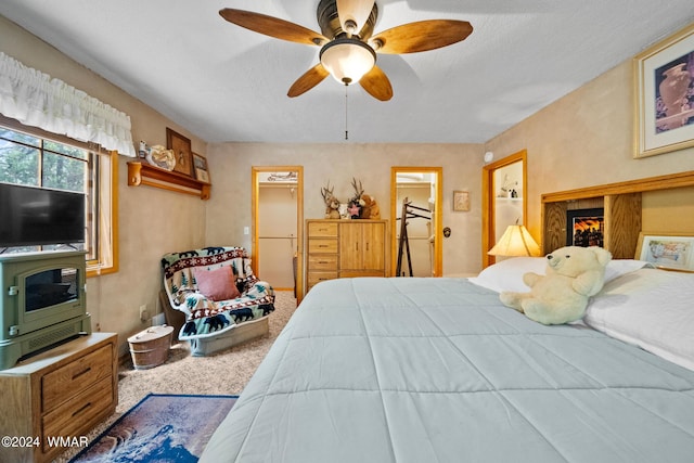 bedroom featuring a ceiling fan and carpet