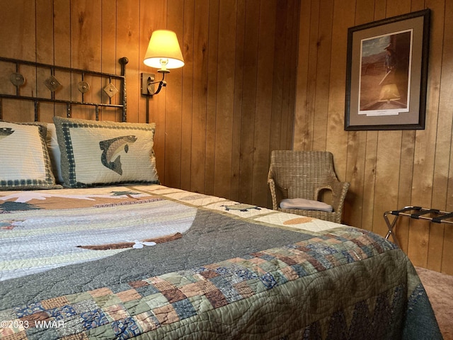 bedroom featuring wooden walls