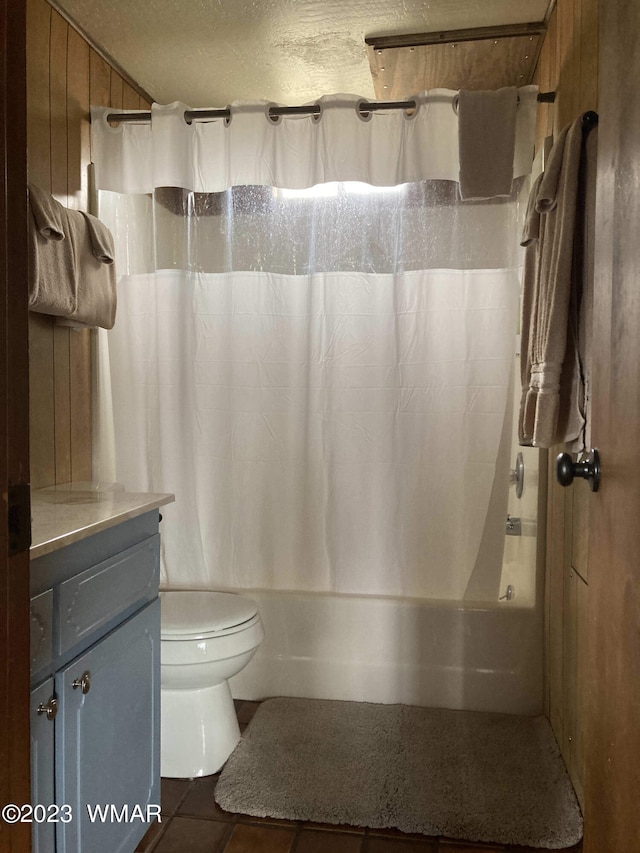 full bath featuring a textured ceiling, tile patterned flooring, toilet, vanity, and shower / bathtub combination with curtain