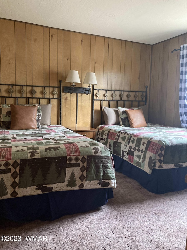 carpeted bedroom featuring wooden walls