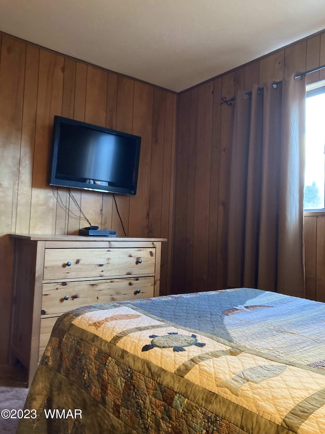 bedroom featuring wooden walls