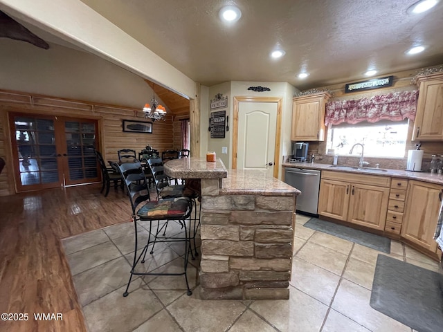 183 N Becker Lake Rd, Springerville, AZ 85938 - kitchen with dishwasher, a breakfast bar, light brown cabinetry, a chandelier, and recessed lighting