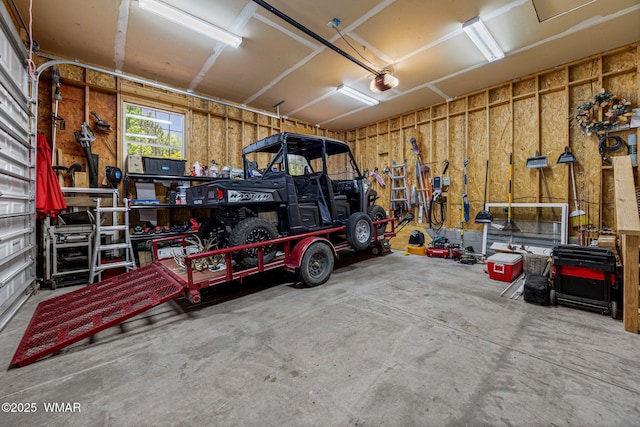 1415 N Lake View Cir, Lakeside, AZ 85929 - garage featuring a garage door opener and a workshop area