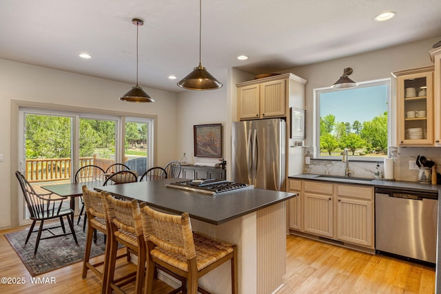 1415 N Lake View Cir, Lakeside, AZ 85929 - kitchen featuring stainless steel appliances, dark countertops, a breakfast bar area, light wood-style flooring, and tasteful backsplash
