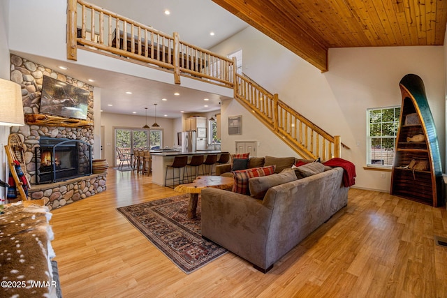 1415 N Lake View Cir, Lakeside, AZ 85929 - living area with light wood-style flooring, a towering ceiling, a stone fireplace, stairway, and recessed lighting