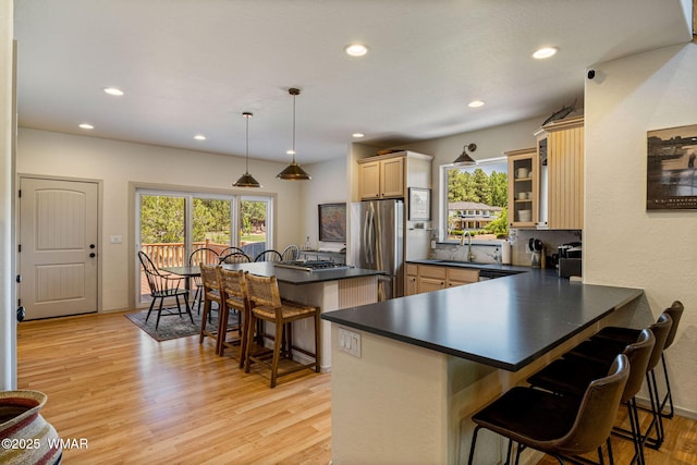1415 N Lake View Cir, Lakeside, AZ 85929 - kitchen featuring freestanding refrigerator, dark countertops, a kitchen breakfast bar, healthy amount of natural light, and recessed lighting