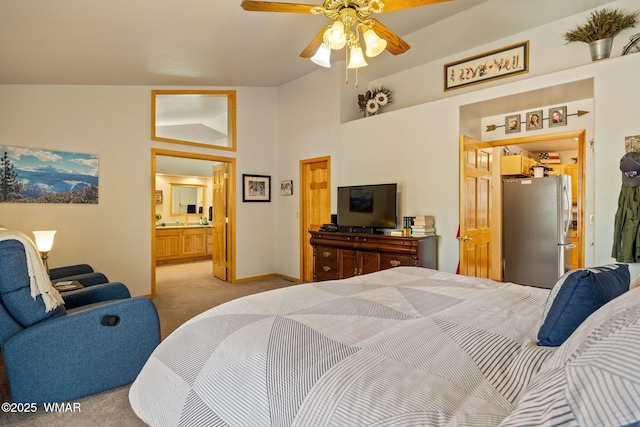 bedroom with light carpet, connected bathroom, freestanding refrigerator, and baseboards