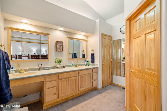 full bath with double vanity, recessed lighting, lofted ceiling, and a sink