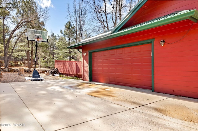 garage featuring concrete driveway