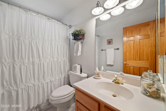 bathroom featuring vanity, a shower with shower curtain, and toilet