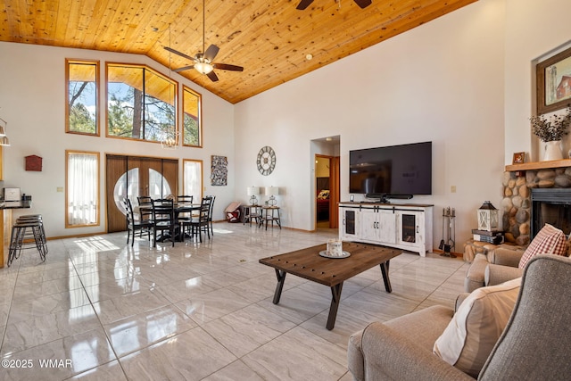 living room featuring baseboards, marble finish floor, ceiling fan, and wooden ceiling