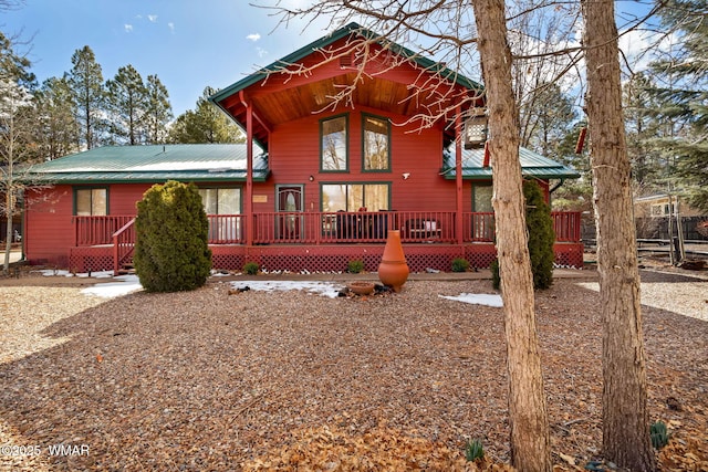 rear view of property featuring metal roof