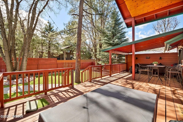 wooden terrace featuring outdoor dining space and fence