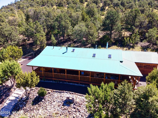 birds eye view of property featuring a wooded view