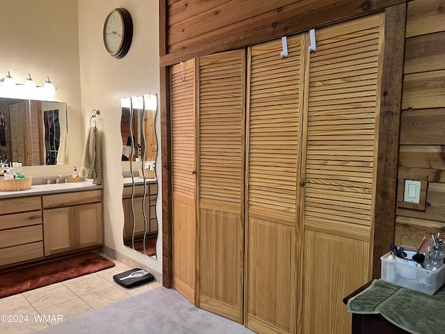 bathroom with tile patterned floors, a closet, and vanity