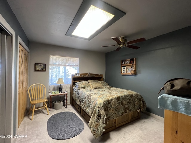 bedroom featuring baseboards, a ceiling fan, and light colored carpet