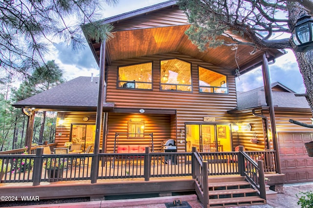 back of property with log veneer siding and roof with shingles