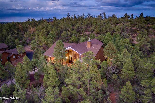 drone / aerial view featuring a view of trees