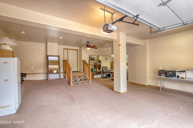 garage featuring a garage door opener, freestanding refrigerator, baseboards, and recessed lighting