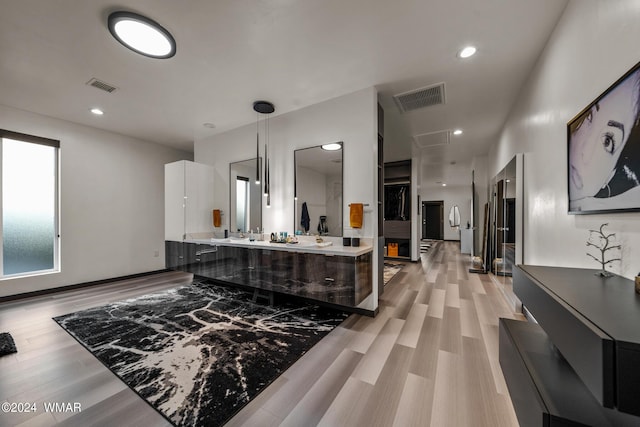 full bath with recessed lighting, wood finished floors, visible vents, and double vanity