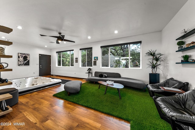 living area featuring wood finished floors, a ceiling fan, and recessed lighting