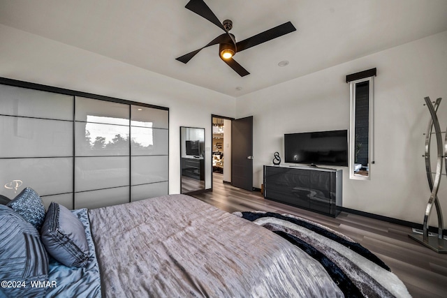 bedroom featuring ceiling fan, dark wood-type flooring, and baseboards