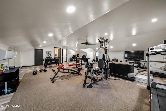 workout area featuring lofted ceiling, wood finished floors, and recessed lighting