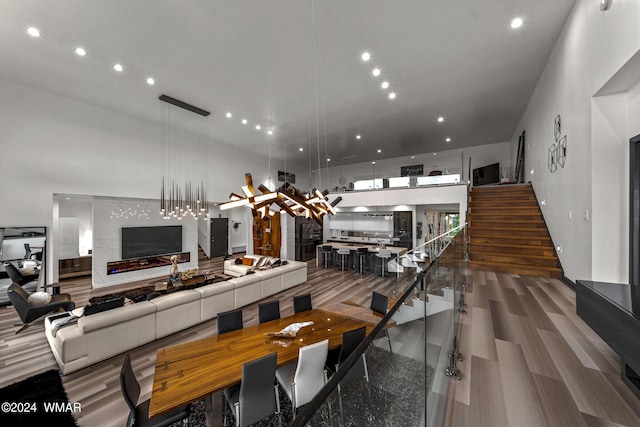 dining space with recessed lighting, a fireplace, and stairs