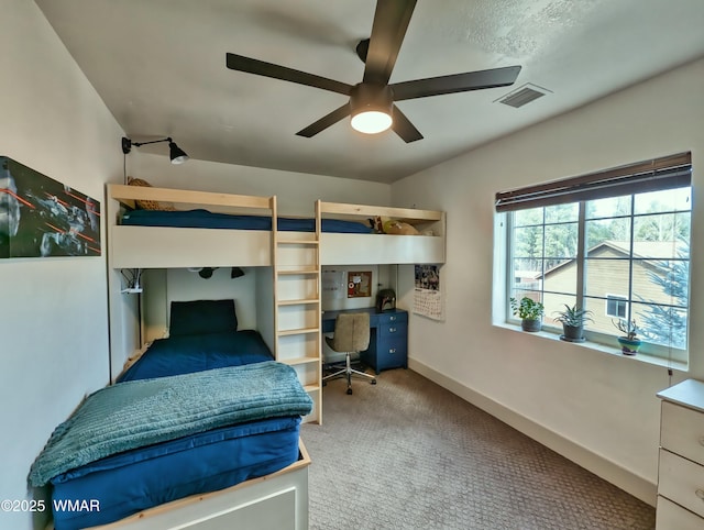 carpeted bedroom with baseboards, visible vents, and ceiling fan