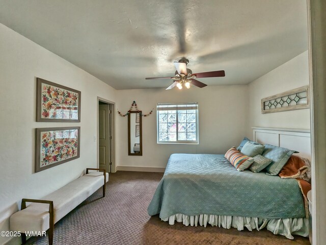 carpeted bedroom featuring a ceiling fan and baseboards