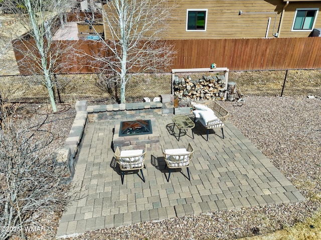 view of patio featuring a fire pit and fence