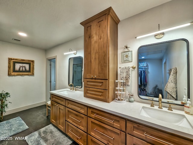 full bath with a sink, visible vents, baseboards, and double vanity