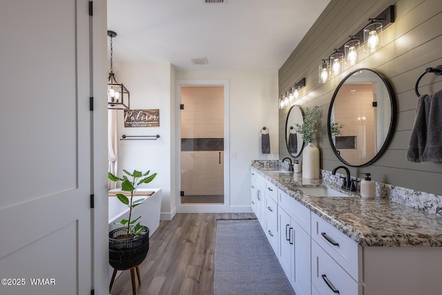 7758 James Pearce Way, Taylor, AZ 85939 - full bath with double vanity, wood finished floors, and a stall shower