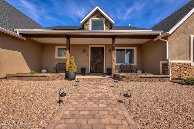 7758 James Pearce Way, Taylor, AZ 85939 - view of exterior entry with stucco siding, a porch, and stone siding