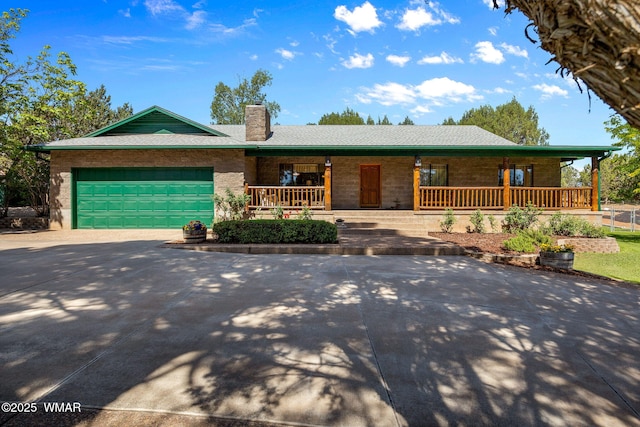 1030 Chamberlain Way, Show Low, AZ 85901 - ranch-style house with a porch, concrete driveway, a chimney, and a garage