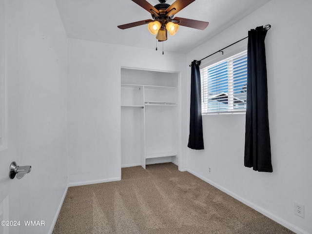 unfurnished bedroom with baseboards, a closet, a ceiling fan, and light colored carpet