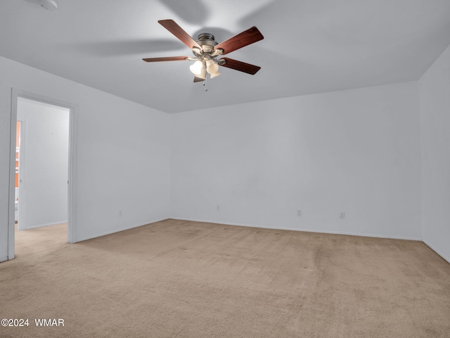 unfurnished room with ceiling fan and light colored carpet