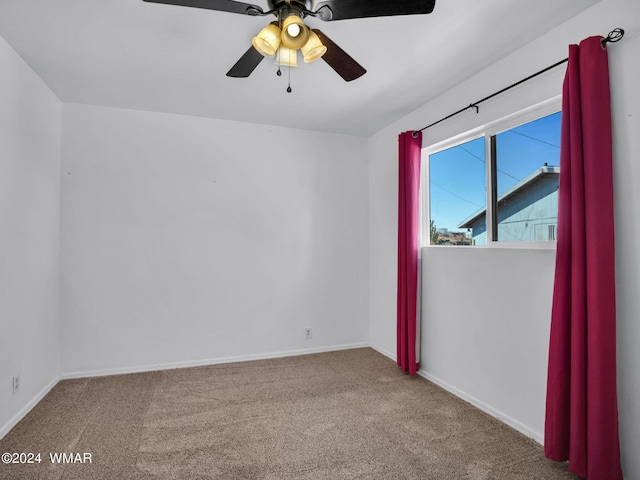 unfurnished room with carpet, baseboards, and ceiling fan