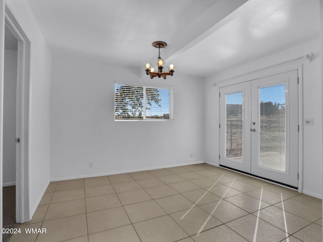 unfurnished dining area featuring light tile patterned floors, baseboards, a chandelier, and french doors