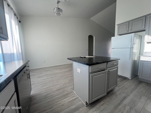 420 Washington St, Snowflake, AZ 85937 - kitchen featuring freestanding refrigerator, stainless steel dishwasher, arched walkways, a center island, and gray cabinetry