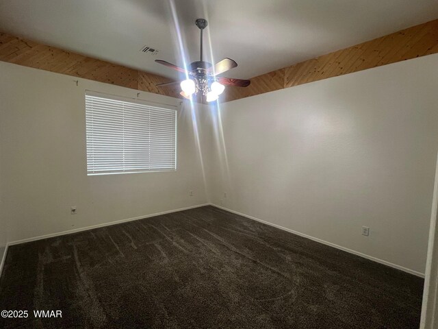 420 Washington St, Snowflake, AZ 85937 - empty room with visible vents, baseboards, a ceiling fan, and dark colored carpet