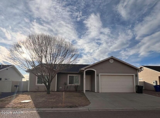 ranch-style house featuring a garage and concrete driveway