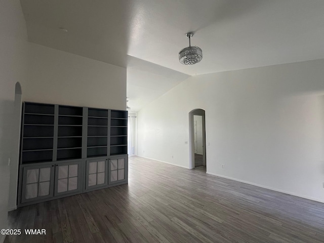 420 Washington St, Snowflake, AZ 85937 - empty room with arched walkways, wood finished floors, baseboards, and vaulted ceiling