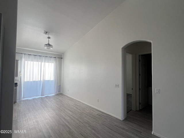 420 Washington St, Snowflake, AZ 85937 - empty room featuring arched walkways, wood finished floors, and baseboards