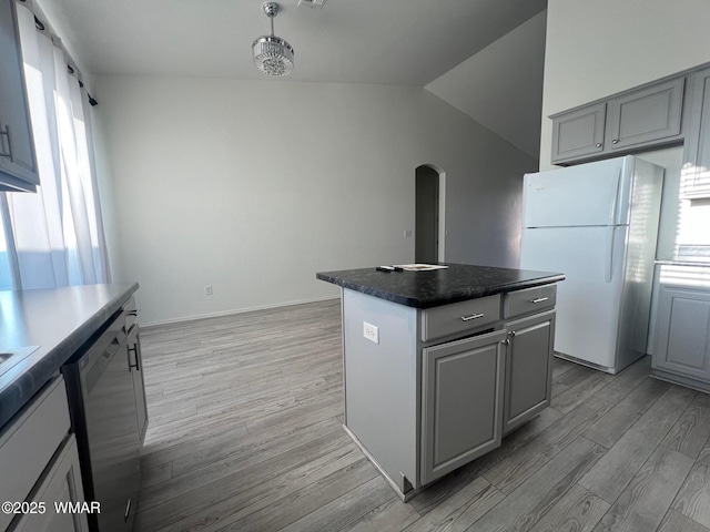 420 Washington St, Snowflake, AZ 85937 - kitchen featuring freestanding refrigerator, a kitchen island, gray cabinetry, arched walkways, and dishwasher
